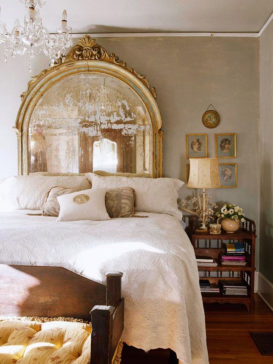 beautiful antique gold mirror behind a bed